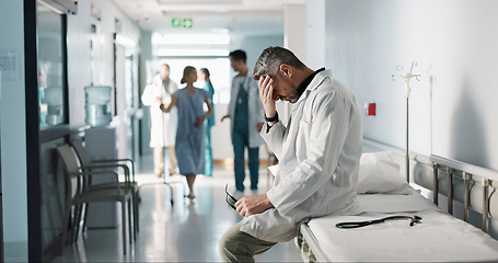 Image showing Depression, grief or fail with a mature doctor in a hospital looking unhappy for healthcare or medical. Stress, mistake or loss with a sad man medicine professional in a professional medicare clinic