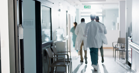 Image showing Doctors, group and running in corridor for emergency, surgery and healthcare work in hospital. Medical teamwork, men and women with call in hallway for wellness, care and support with back in clinic