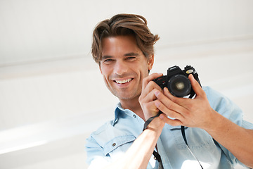 Image showing Pride, camera and portrait of man photographer at a photoshoot for creative work project. Happy, photography and handsome young male person with dslr device for art career by white studio background.