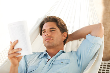 Image showing Reading, relax and young man on a hammock with a book for information or knowledge in backyard. Resting, calm and male person enjoying a story or novel on a body swing outdoor at modern apartment.