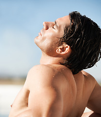 Image showing Outdoor, sunshine and man with vacation, beach and tan with break, getaway and weekend trip. Person, calm and guy with seaside holiday, sunlight and relax with basking, wet and summer with freedom