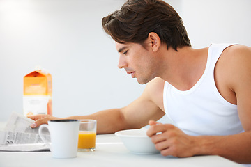 Image showing Home, relax and man with breakfast, newspaper and information with food, smile and juice. Happy person, apartment and guy with health, morning meal and kitchen with newsletter, wellness and reading