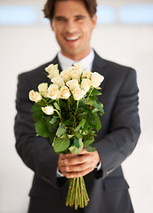 Image showing Gift, portrait and happy man with flowers for love, giving or valentines day celebration on wall background. Face, roses and person with bouquet for anniversary, romance or congratulations gesture