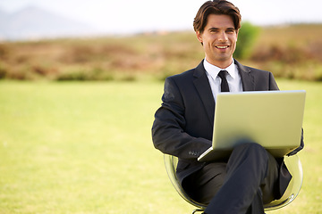 Image showing Portrait, laptop and businessman on chair in nature, typing email online on pc or remote work outdoor on mockup space. Computer, smile or professional lawyer in countryside on technology to freelance