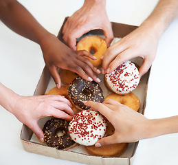 Image showing Donut, box and hands of people with delivery of food in office, meeting or white background in studio. Hungry, group and employees eating doughnuts for snack break in company and workplace mockup