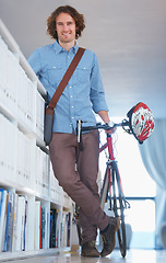 Image showing Man, portrait with bike and sustainable travel, worker at office with carbon footprint, transportation and creative at startup. Happy, cycling for eco friendly bicycle and professional at workplace