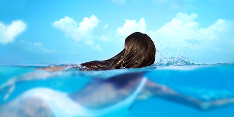Image showing Woman, nature and ocean swimming for travel, holiday and sea water on a tropical island. Hawaii, outdoor and female person relax on a summer vacation with peace and adventure by beach in paradise
