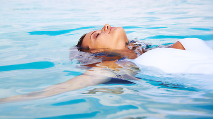 Image showing Woman, calm float and ocean swimming for travel, holiday and sea water on tropical island. Hawaii, outdoor and female person relax on summer vacation with freedom and adventure by beach in paradise