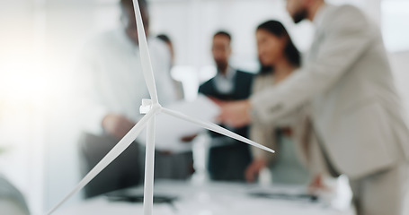 Image showing Business people, meeting and wind turbine for eco friendly, sustainability and renewable energy planning in office. Windmill model, design and engineering team with documents in agriculture solution