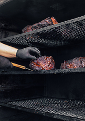 Image showing Meat prepared in barbecue smoker.