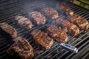 Image showing Beef steaks on grill