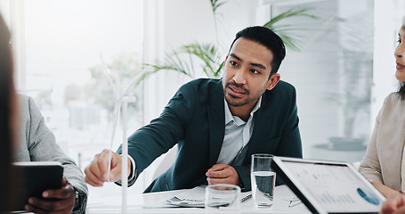 Image showing Wind turbine, planning and man talking in office working on clean energy and sustainability electricity. Engineering, construction project and architect with eco friendly and biodiversity design