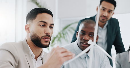 Image showing Wind turbine, design planning and man talk in office working on clean energy and sustainability group. Engineering, construction project and architect with eco friendly and biodiversity design