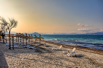 Image showing Can Picafort Beach with straw umbrellas and sun loungers, Can Picafort, Balearic Islands Mallorca Spain.