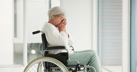 Image showing Sad, senior woman and person with disability, wheelchair and crying into hands at the hospital, window or nursing home. Depressed, mental health and elderly person frustrated, thinking in retirement