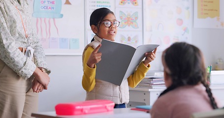 Image showing Child, reading and classroom with girl speaker, book and education at a school. Students, learning and notebook with development, knowledge and study work with story discussion of youth assessment