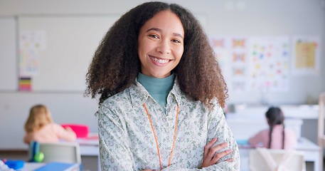 Image showing Female teacher, arms crossed and smile in class with school kids, pride or happy for education career. Woman, classroom and learning expert for children, face or portrait with development for future