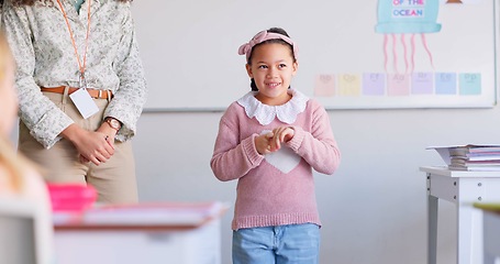 Image showing Class, presentation and happy child speaker with applause and cheering in classroom at school. Young kid, education and talk of project with a student and teacher with children group discussion