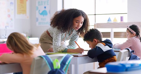 Image showing Help, teacher and woman in a classroom, children and education with studying, lessons and knowledge. Person, educator and students writing, learning and kids with answers, explain test and advice