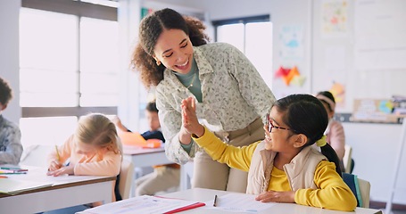 Image showing Teacher woman, high five girl and classroom with achievement, success and mentorship for learning. Education, development and students with goals, knowledge and books with celebration at school desk