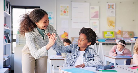 Image showing Teacher woman, high five boy and classroom with achievement, success and mentorship for learning. Education, development and students with goals, knowledge and books with celebration, school and desk