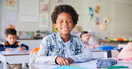 Image showing Smile, education and writing with boy in classroom for learning, knowledge and study. Scholarship, happy and future with portrait of young student at school for academy, exam test and project