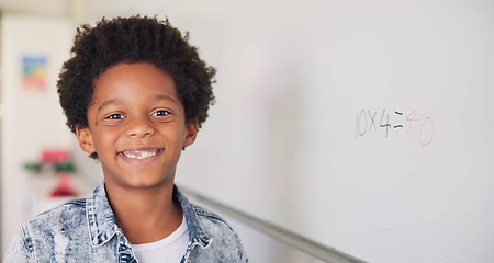 Image showing Math class, portrait of child at board for education, learning and problem solving for skill development. Boy at whiteboard in classroom with smile, happiness and solution at school for knowledge.