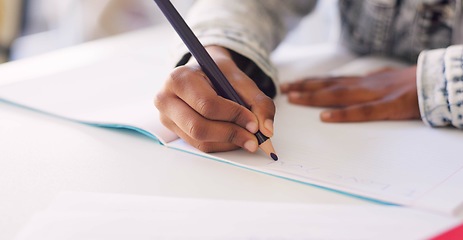 Image showing Hands, kid and writing in book, classroom and learning with development, language or paper at desk. Child, scholarship and education with notebook, pen and studying at academy, school or kindergarten