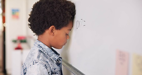 Image showing Math class, sad child at board for education, learning and problem solving for skill development. Boy at whiteboard in classroom with struggle, thinking and stress at school for solution in knowledge