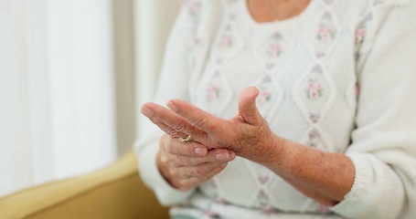 Image showing Hands, pain and arthritis with an old woman in her nursing home, struggling with a medical injury or problem. Healthcare, ache or carpal tunnel with a mature resident in an assisted living house