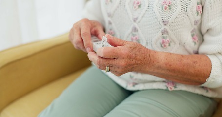 Image showing Sick, medicine and hands of person on the sofa for routine medical supplement in a house. Closeup, daily and a woman with pills, tablet or vitamin c for healthcare on the living room couch of a home