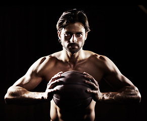 Image showing Muscle, body and portrait of man with basketball in studio isolated on black background. Sports, serious face and strong athlete with ball, abs or workout, fitness or training to exercise for health