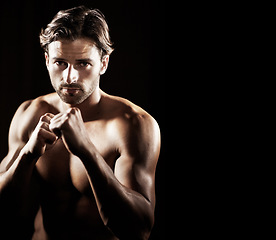 Image showing Portrait, body of man and fist of boxer in studio isolated on black background mockup space. Serious face, boxing and muscle of topless athlete ready for fight, exercise or training, sport or fitness