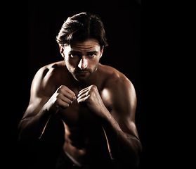 Image showing Portrait, body of man and boxer fight in studio isolated on a black background. Face, boxing and muscle of topless athlete with fist ready for exercise, training or workout, sport and combat fitness