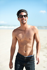 Image showing Summer, sunglasses and the body of a man on the beach for travel, freedom or adventure on vacation. Nature, sand and a young person shirtless by the ocean or sea on a tropical coast for holiday