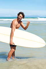 Image showing Beach sports, surf portrait and happy man with come gesture for water activity, training or ocean wellness. Surfboard, nature cardio and surfer invitation for exercise, workout or sea adventure