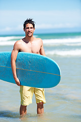 Image showing Man, surf and portrait for workout, training and waves with water sport and exercise outdoor of athlete. Surfer, freedom and vacation by the ocean and beach for summer wellness and fitness in nature