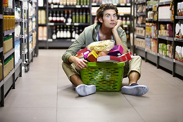 Image showing Man, grocery shopping and supermarket, stress about inflation and expensive food, overwhelmed in store. Groceries in basket, retail and customer shocked by price, choice and purchase with fear