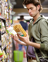 Image showing Man, product and comparison choice in supermarket for label difference, nutrition value or grocery shopping. Male person, thinking and decision for shop aisle deal, wholesale price or discount search