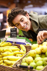 Image showing Man, fruit and supermarket choice for health diet, nutrition or shopping product sale. Male person, happy customer or pear stock in grocery store for organic vegan offer, quality price or fibre food