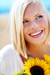 Image showing Happy woman, face and thinking with flowers for summer break, eco friendly or vacation in nature. Closeup of female person smile in happiness with plant, outdoor or petal for season change outside