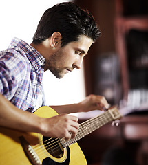 Image showing Guitar, tuning or man in house for music, performance or entertainment in living room with talent. Learning solo, acoustic strings or creative musician playing an instrument for artistic expression