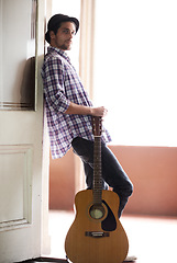 Image showing Musician, portrait and man with a guitar, instrument and singer in a music studio. Creative, artist and guitarist standing in home and thinking of performance, equipment or listening to rock audio