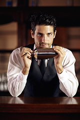 Image showing Bartender, portrait and cocktail mixer for a drink, customer or dark club at night. Mixing, alcohol and face of barman with vodka or liquor in metal container or shaker for a strong beverage in a bar