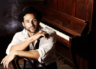 Image showing Portrait, artist and man with a piano, smoking and creative with talent, performance and gig. Face, musician and club with a cigarette, jazz and ambient with tobacco, smile and confident player