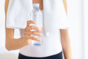 Image showing Water bottle, hands or woman with health, fitness or wellness for hydration after exercise or training. Thirsty sports person, closeup or healthy athlete with liquid or aqua after workout to relax