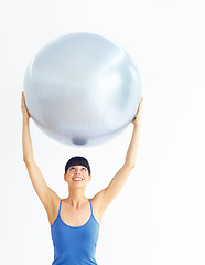 Image showing Woman, exercise or ball with stretching for pilates, exercise or workout on muscle, posture and wellness. Person, arm or stretch for yoga, training or fitness with sportswear and technique in studio