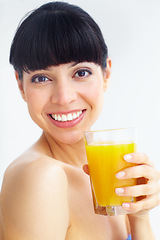 Image showing Orange juice, studio portrait and happy woman with glass drink for hydration, liquid fruit detox or natural weight loss. Vitamin C, organic beverage and face of person thirsty on white background