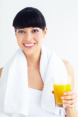 Image showing Orange juice, fitness studio portrait and happy woman with glass drink for training, cardio or exercise hydration. Relax, happiness and girl thirsty for liquid, citrus or beverage on white background