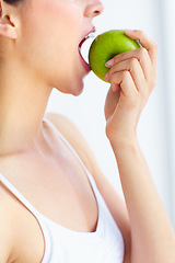 Image showing Closeup, eating and woman with health, apple or wellness with detox on a white studio background. Person, girl or model with fruit, nutrition or hungry with diet plan, food or natural with digestion